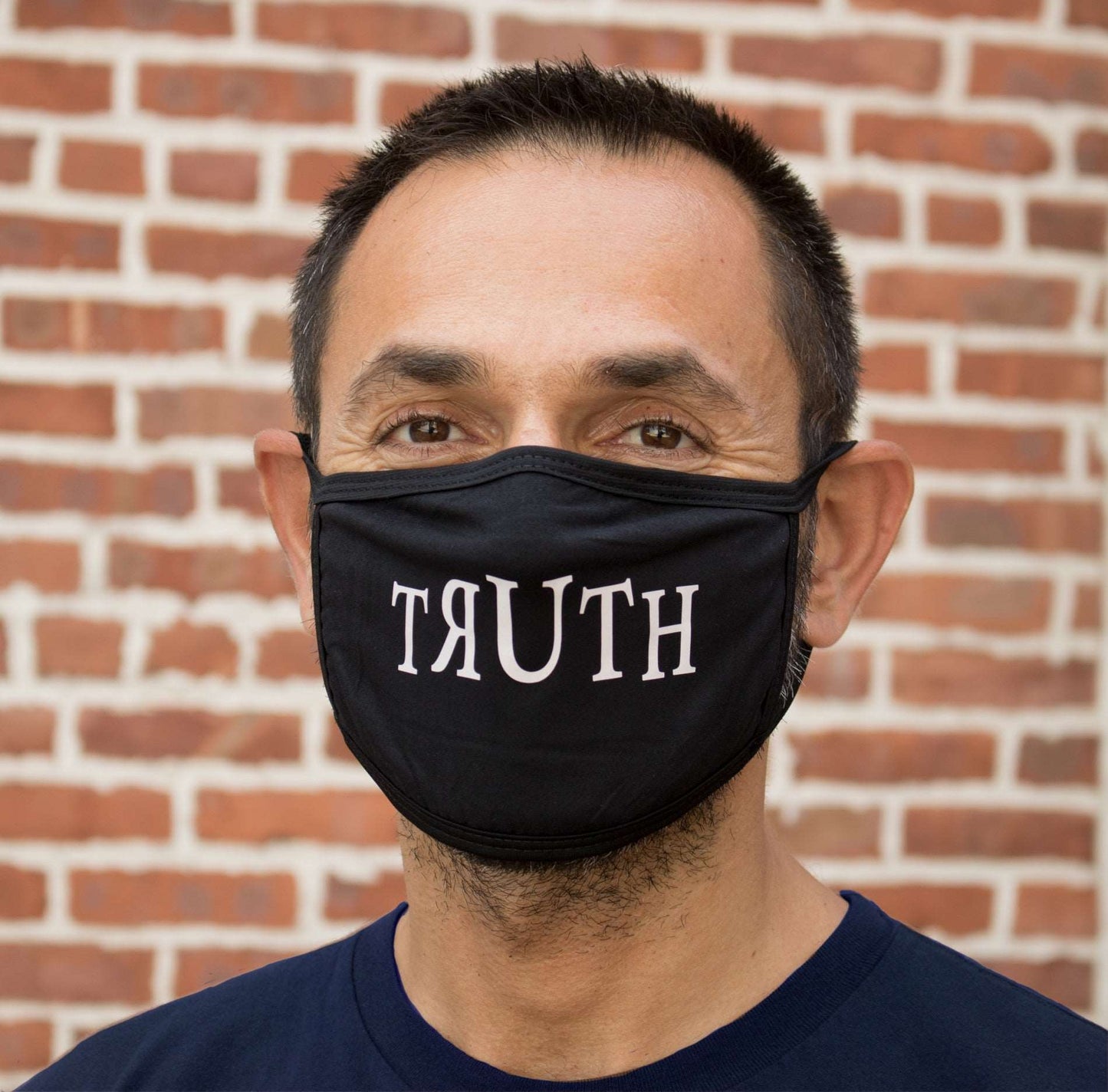 Ligorano Reese's cotton polyester blend face mask that says it like it really us - The Truth - for all to see. Made in the Brooklyn Navy Yard. Produced during the early days of COVID. Male model. From Pure Products USA.