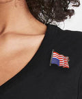 Ligorano Reese's Dress For Distress upside down American flag pin on blouse. Gold enamel. Butterfly clutch. From Pure Products USA.