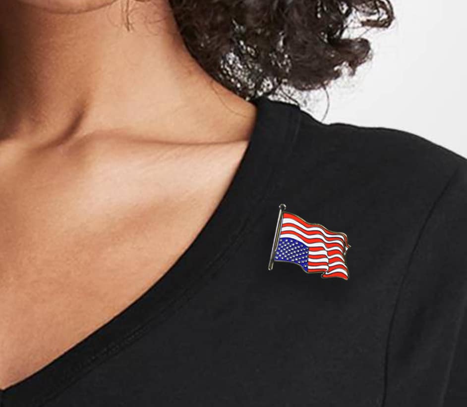 Ligorano Reese's Dress For Distress upside down American flag pin on blouse. Gold enamel. Butterfly clutch. From Pure Products USA.