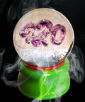 Ligorano Reese's Smoke Gets In Your Eyes 420 deluxe glass snow globe. Signed and numbered limited edition of 25. Smoky purple haze resin cast. Kush Green base with secret stash compartment. From Pure Products USA.