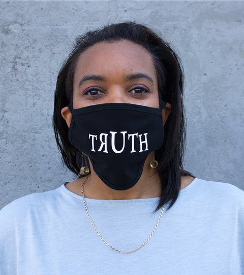 Ligorano Reese's cotton polyester blend face mask that says it like it really us - The Truth - for all to see. Made in the Brooklyn Navy Yard. Produced during the early days of COVID. Female model. From Pure Products USA.